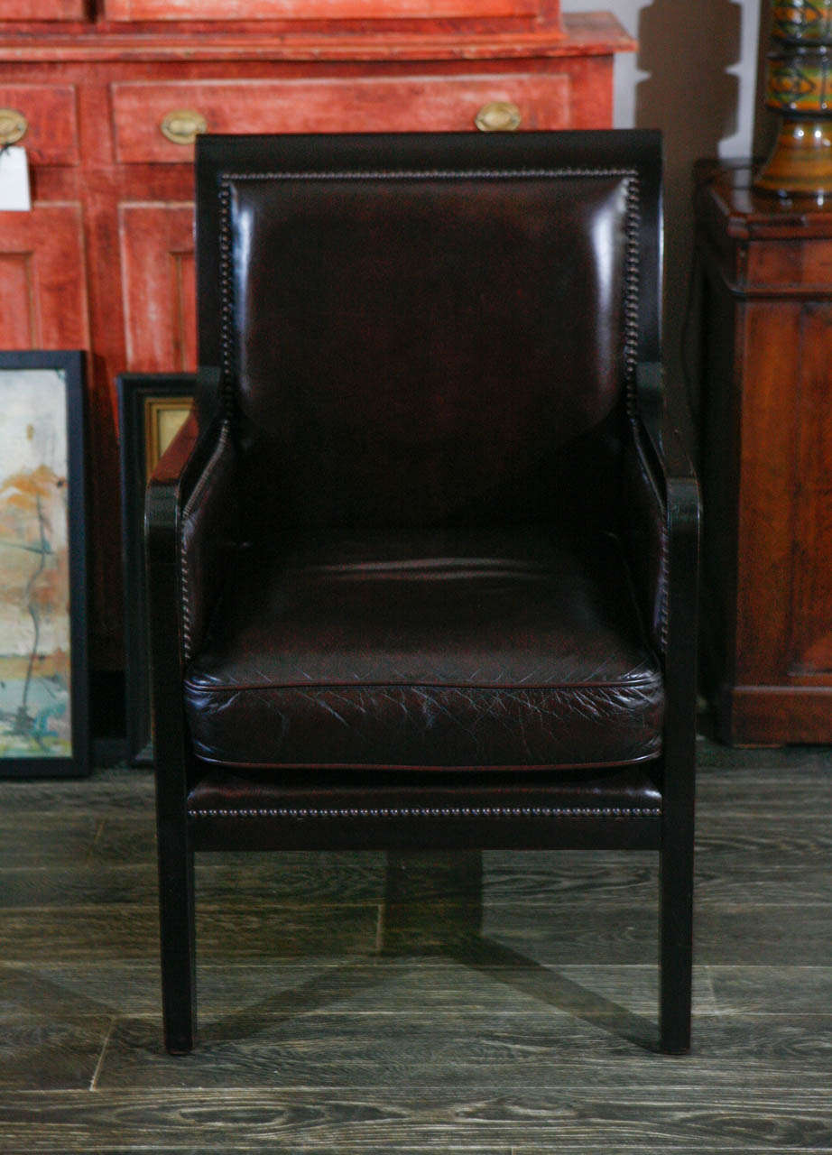Late 19th century pair of ebonized and black leather upholstered chairs. 
