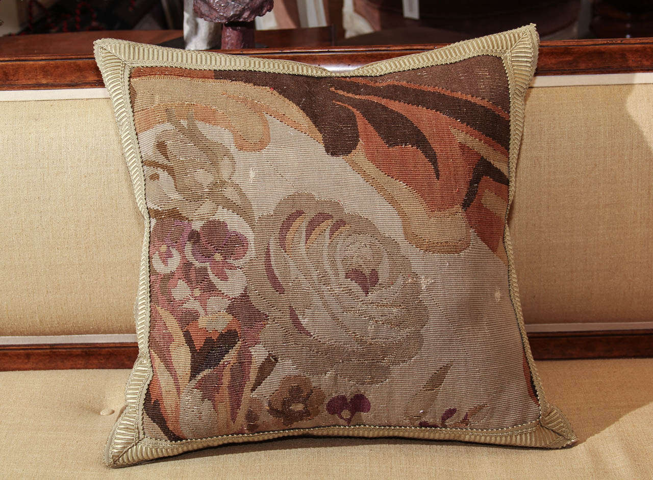 A pillow made from a fragment of 19th century Aubusson carpet. Backed with mohair and with a feather and down fill.