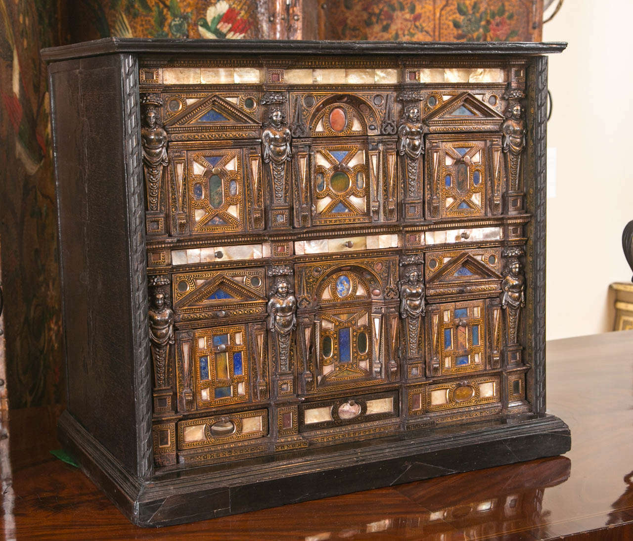An exceptional Italian table cabinet dating from the late 16th to early 17th century in an ebonized case with multiple drawers inset with various semi-precious stones, lapis lazuli, mother of pearl etc. for a similar example see Hans Huth 