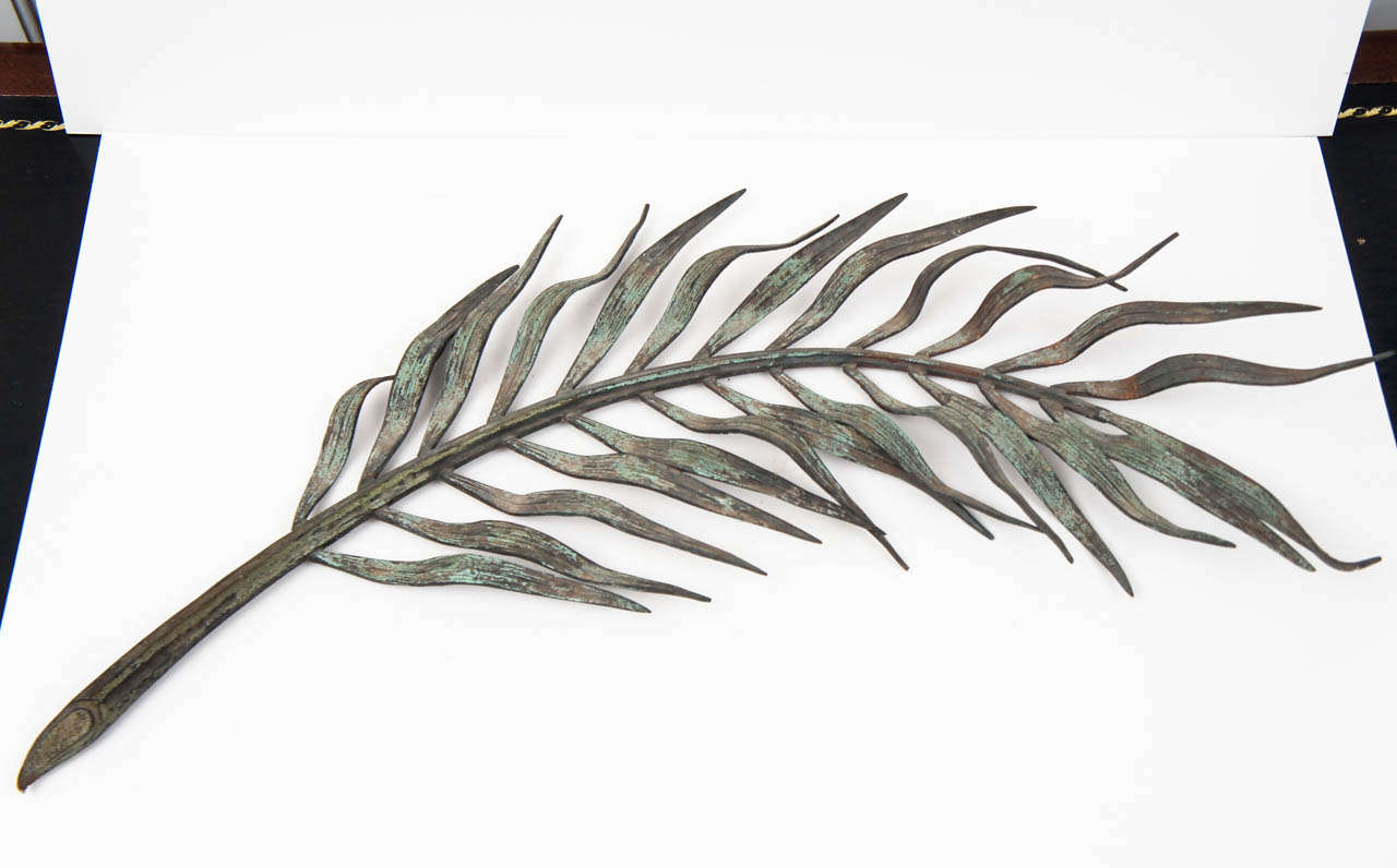 Palm frond wall or tabletop decoration in patinated bronze from Colefax &
Fowler. Signed Jean Rabiant Memorial Frond.