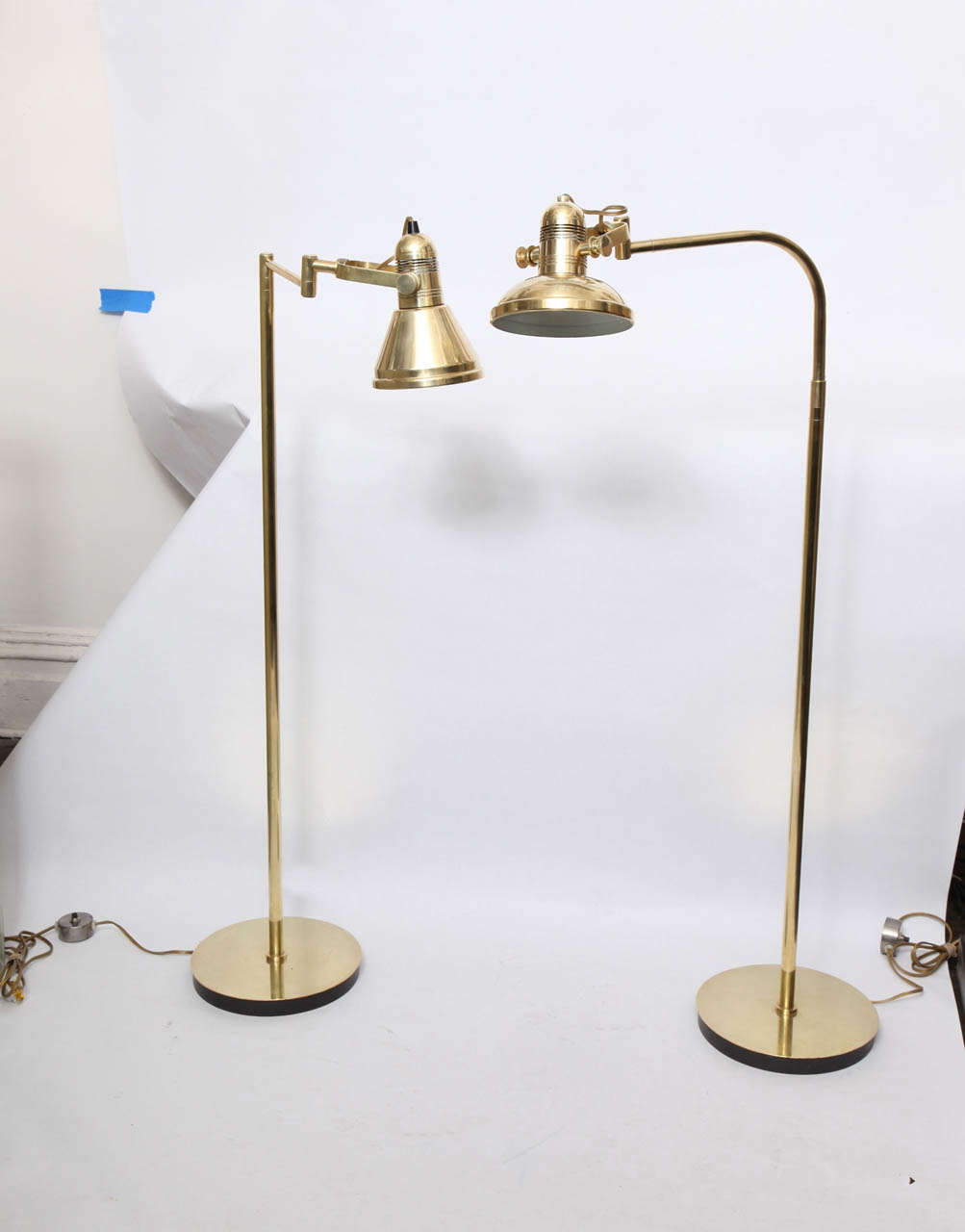 A pair of 1970s articulated brass floor reading lamps by Nessen Studio.