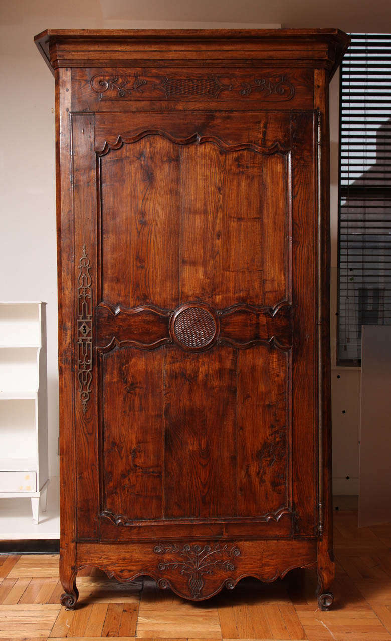 French A Louis XV Style Carved and Stained Walnut Single Door Armoire