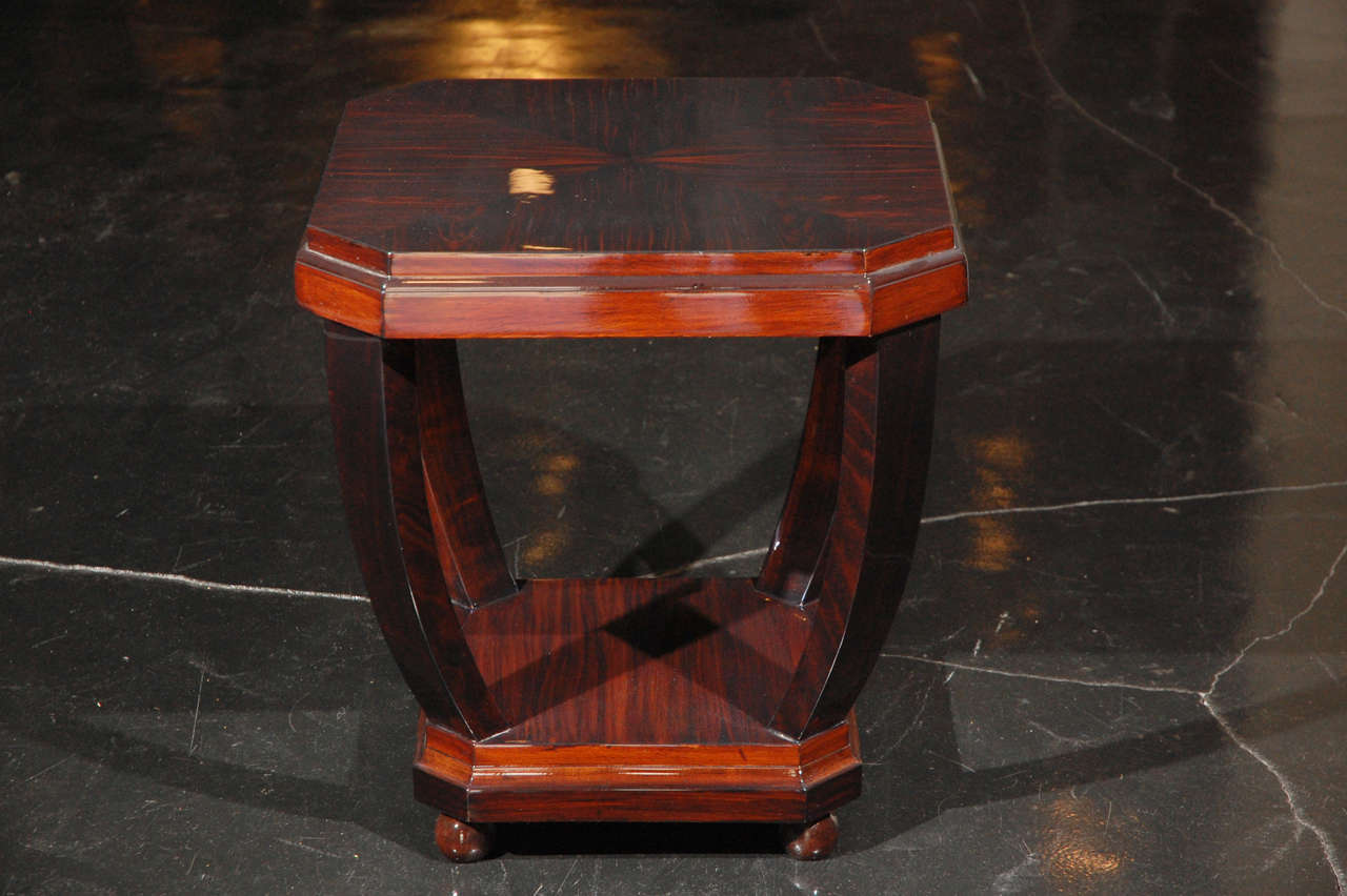 Beautiful side table with Macassar Ebony quartered top and Mahogany details. Two-tiered octagonal shape and arched legs with ball feet.
