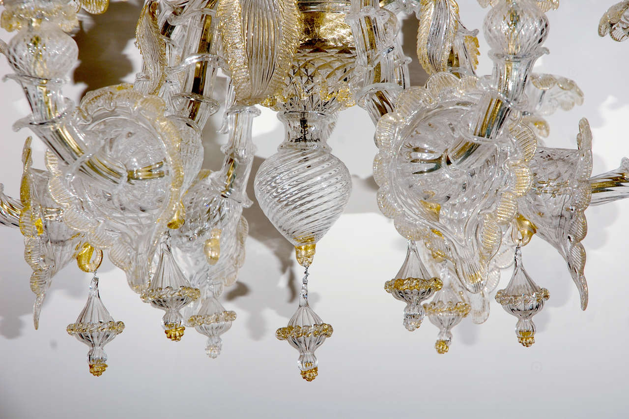 1900’s, Murano chandelier with 22k gold accents, trumpet flower details and floral drops.