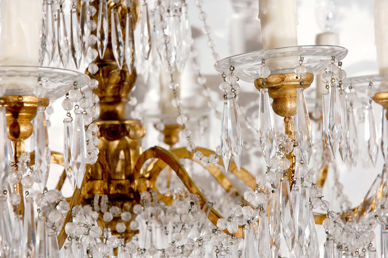 Hand carved gilt-wood chandelier with graceful strings of cut-crystal drops from Genoa, Italy.