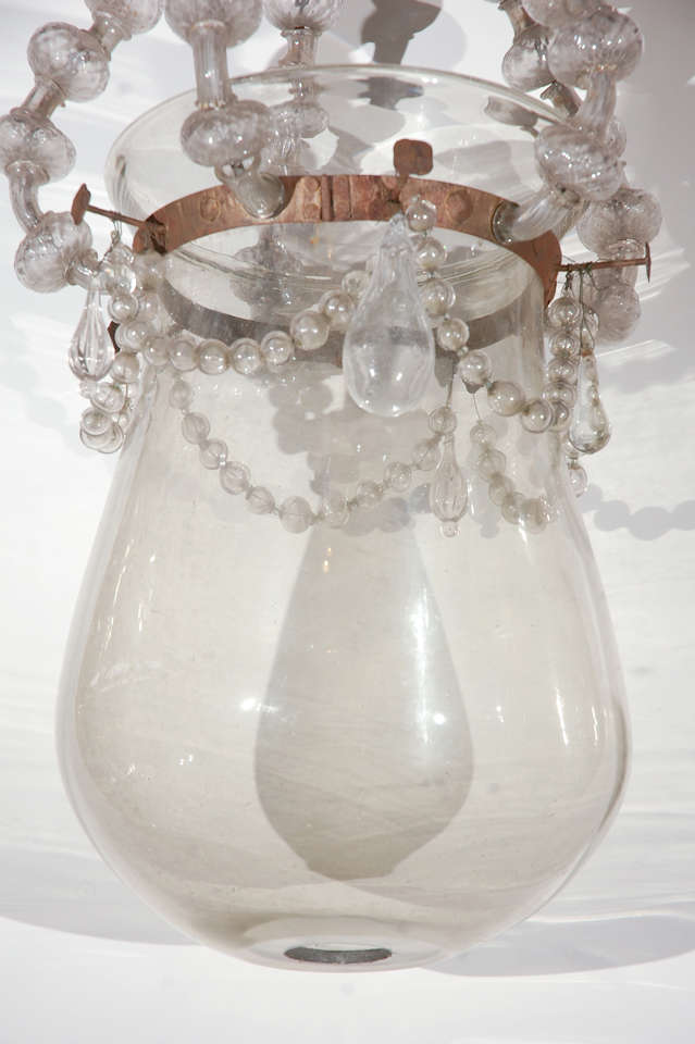 Fabulous, hand blown Murano glass,pendant lantern trimmed in bronze mounts. The canopy sits above five serpentine arms wrapped in fluted glass beads that lead to the main body of the piece which is further embellished with swags of glass pearls