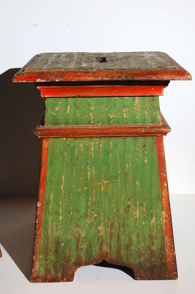 Two, hand-painted stools featuring family crests from Italy.