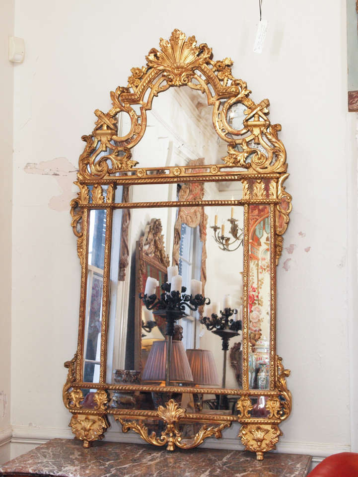 Period French Regence giltwood mirror with exceptional gilt and glazing.