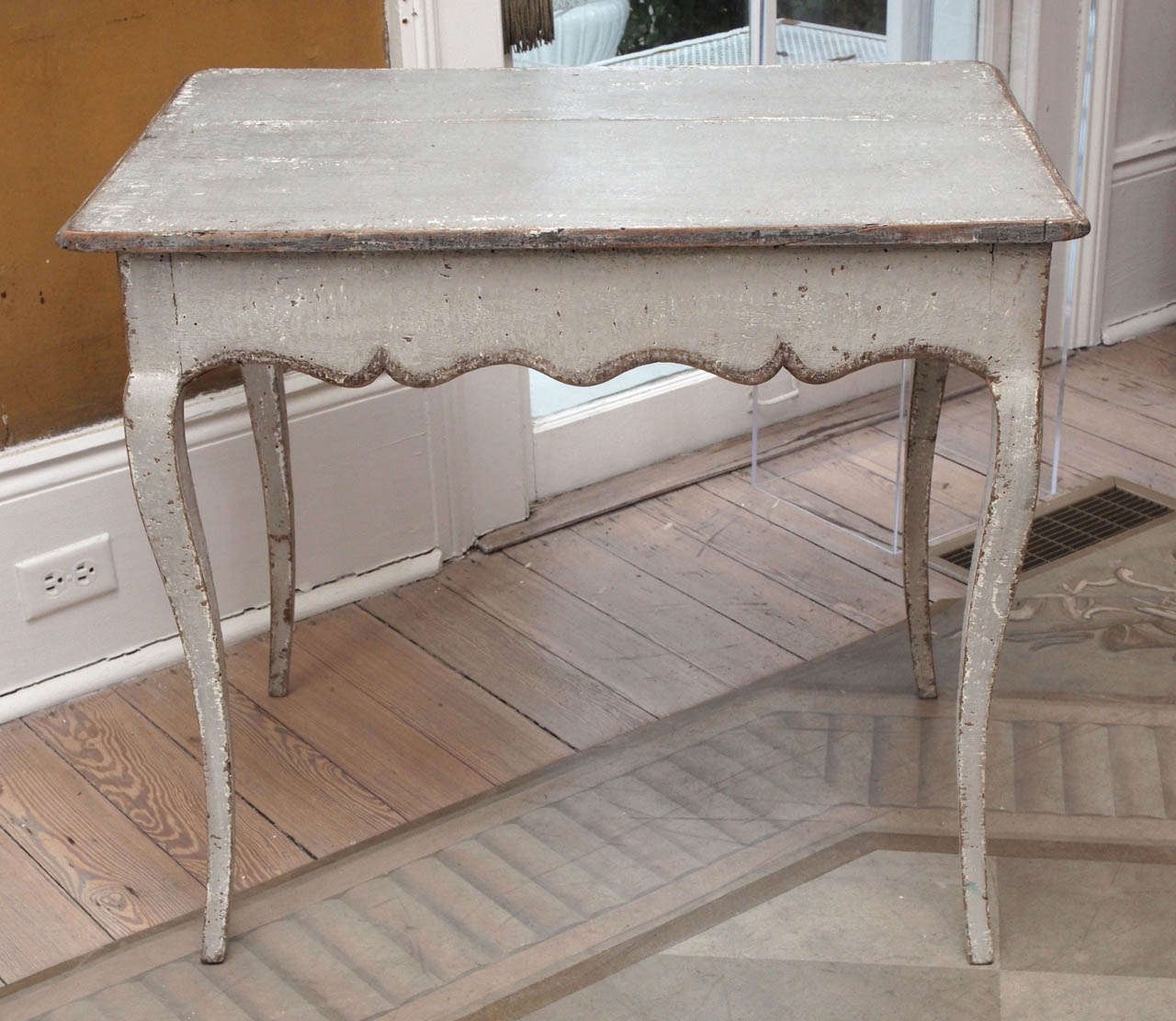 Painted Louis XV style tea table with scalloped apron and cabriole legs.
