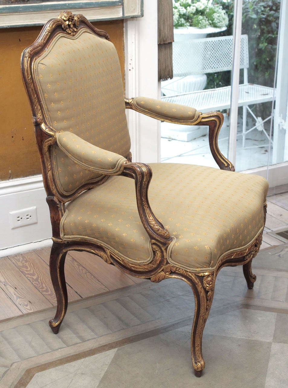 Elegant pair of French fauteuils with detailed gilt painted carving and curving lines.