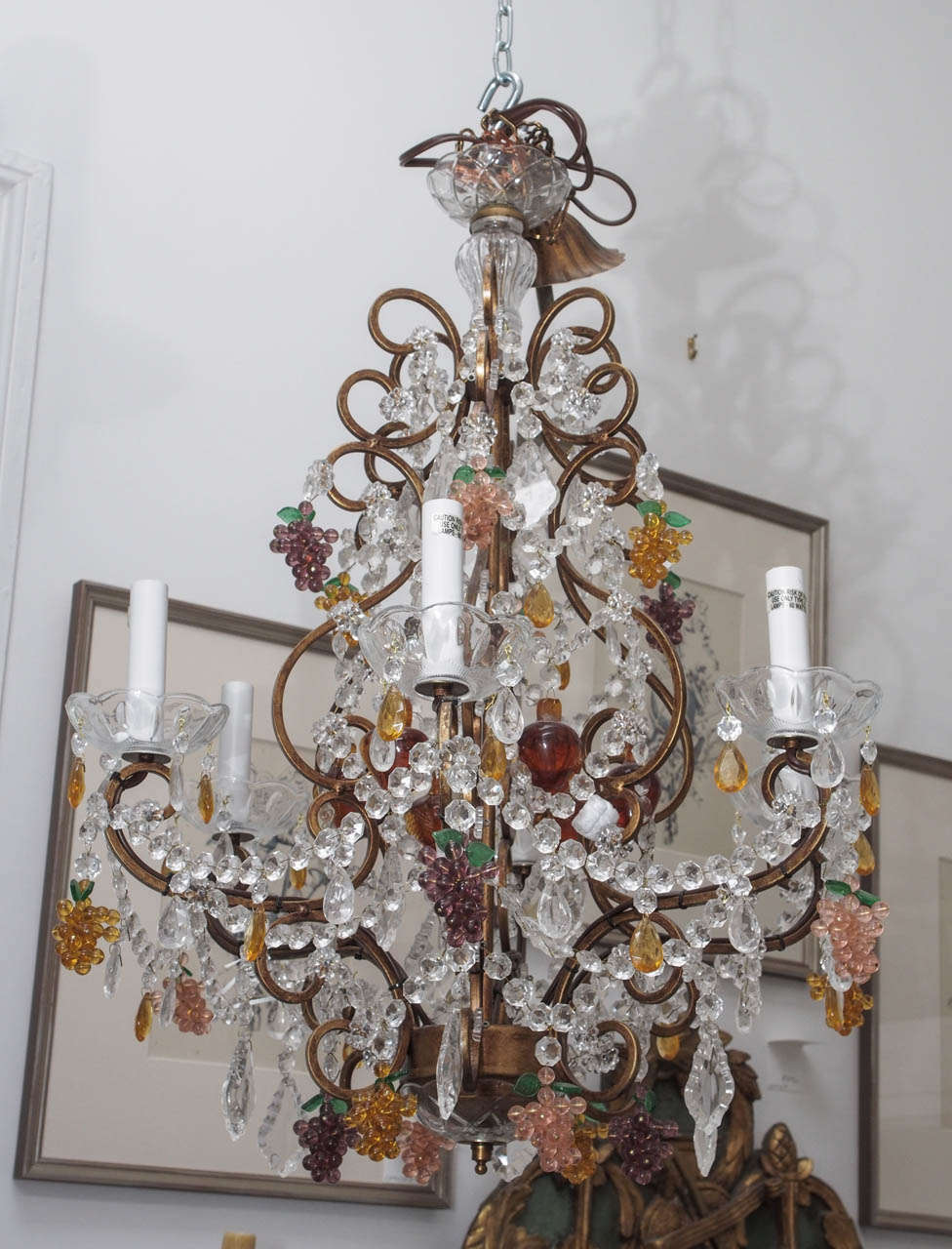 Playful crystal chandelier with purple, pink, and gold crystal grapes.