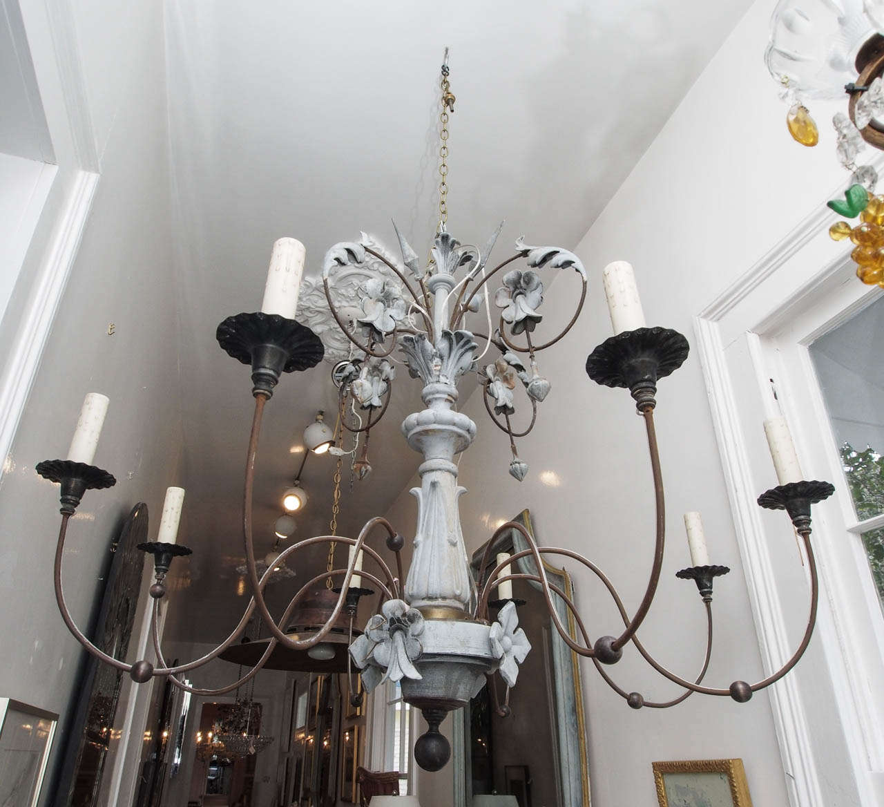 Oversized zinc chandelier with 8 lights and a swirling floral motif.