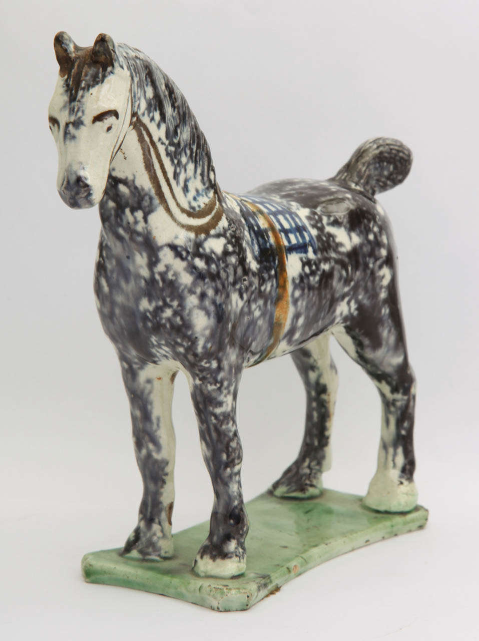 A fine English pearlware pottery standing horse decorated in underglaze Pratt colors