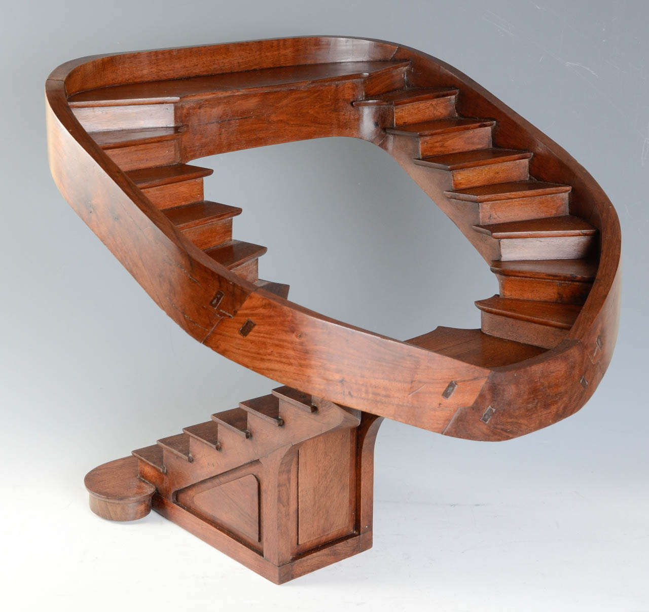 Nine walking steps leading to a half landing where from leave two curved staircases  towards a first floor. French, Walnut, circa 1885.