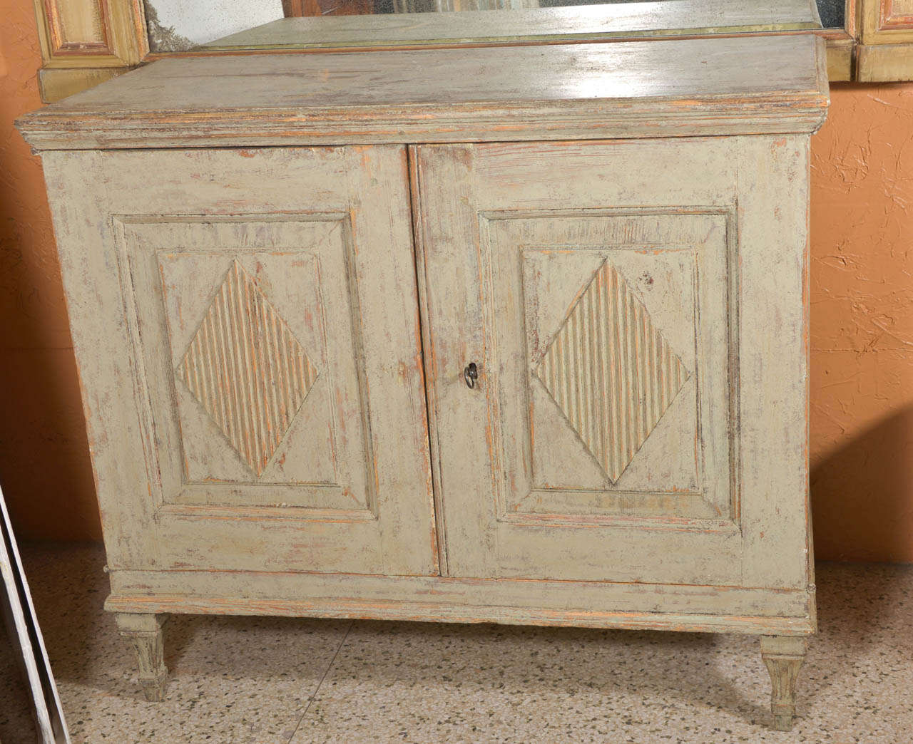 Small two door Gustavian cabinet in scaped painted finish.