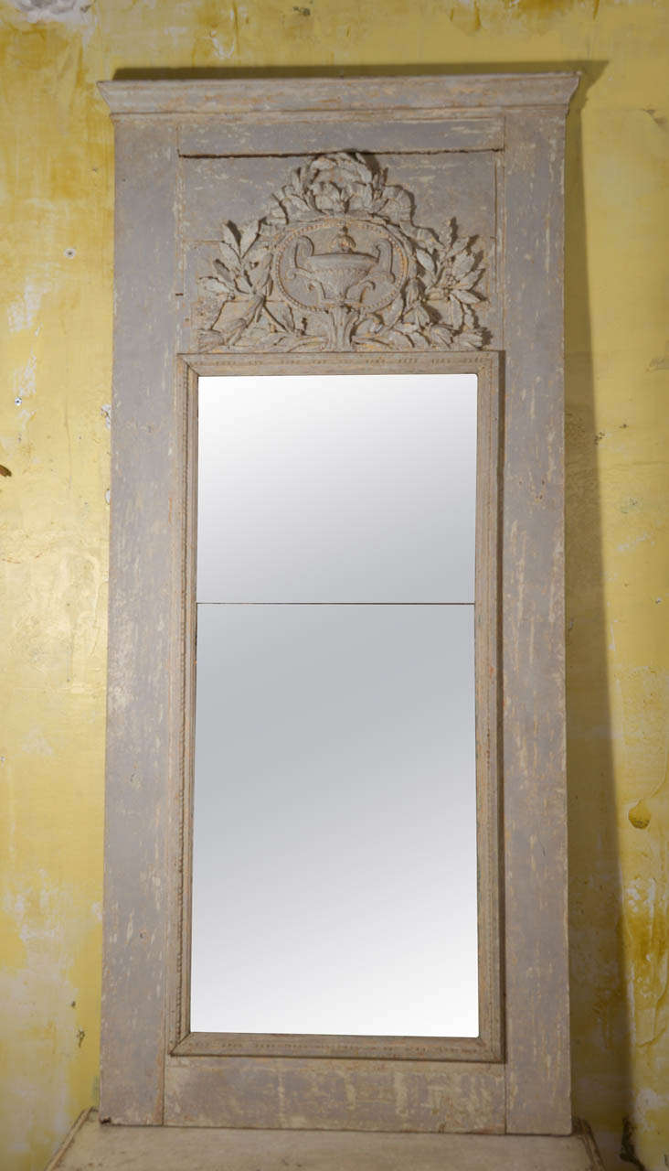 Early 19th c.painted and scraped finish with carving to the top and antique mirror.