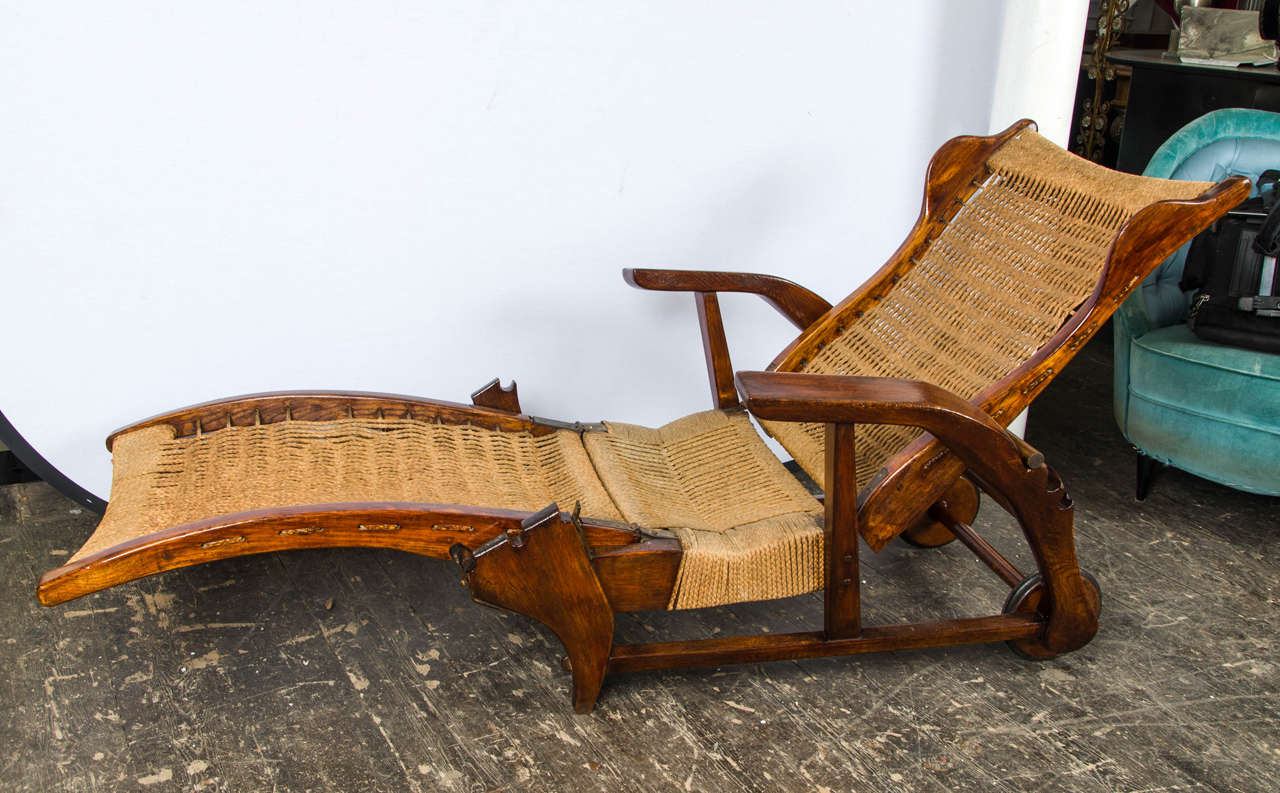 Recline deckchair in walnut and and rope, with two wheels on the back