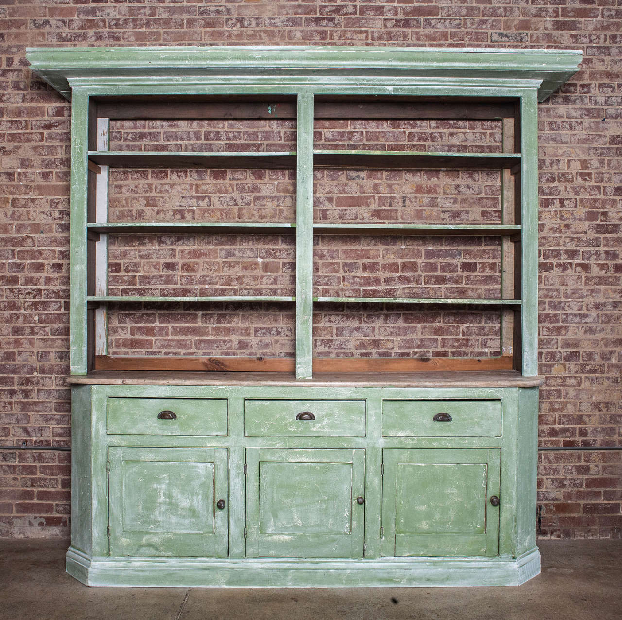 Painted green vaisselier has three doors and three drawers with brass pulls. The three shelves above are a later addition.