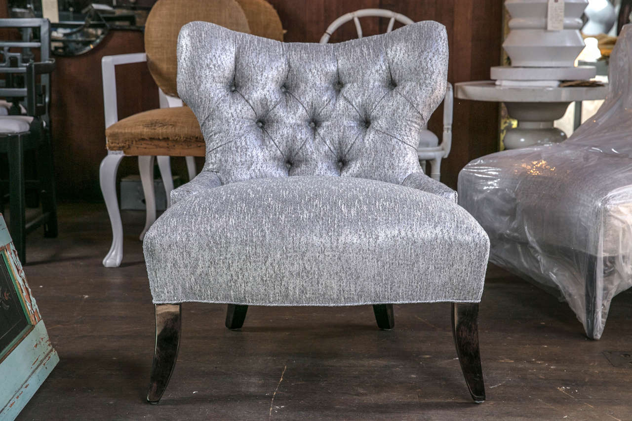 Newly reupholstered Mid-Century, Billy Haines style pair of chairs. The fabric is a metallic grey and ivory bouclé. The splayed legs are ebonized walnut. Slipper or lounge chairs with deep tufting. Inside seat depth is 22".
Also reminiscent of