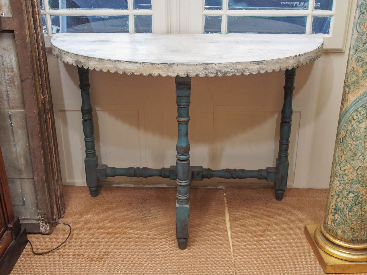 these great scaled demi-lune  tables have beautiful scalloped aprons on the metal tops resting on painted bases.