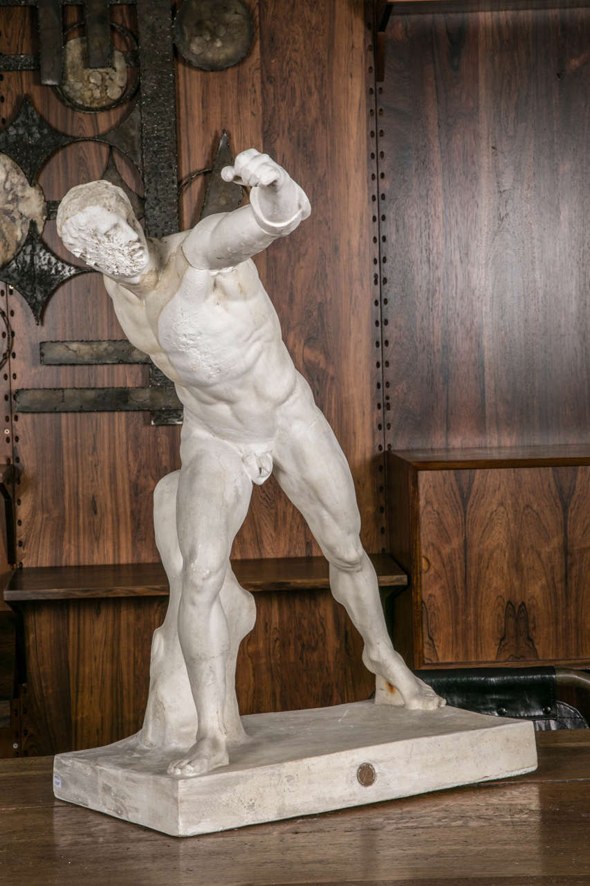 Tall and beautiful early 20th century English reproduction in plaster of a famous warrior part of the Borghese collection, now shown at the Louvre museum. 
The original antique marble statue is attributed to the greek sculptor Agasias.
This statue
