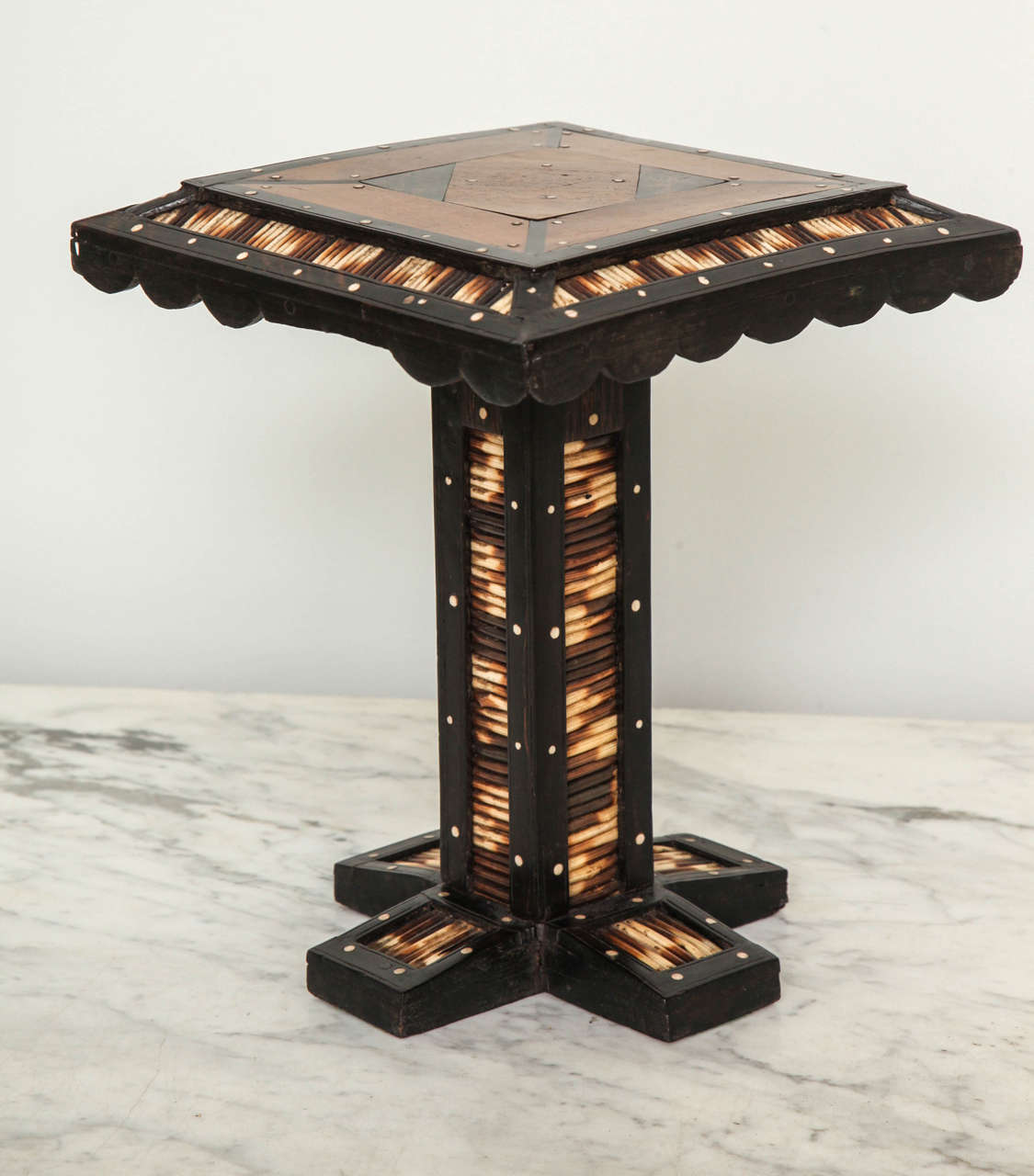 Scarce miniature Ceylonese drinks table, the top inlaid with sandalwood, bone, and ivory, the edge decorated with porcupine quills, the base made from solid ebony with quill ribbing.