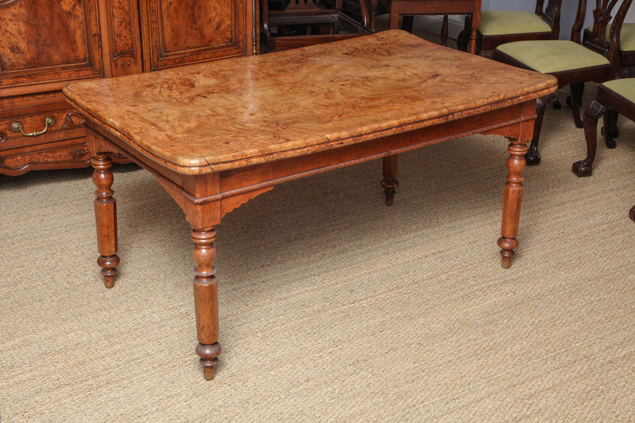 Very desirable early to mid-19th century ash table, the top comprising two bookmatched planks of highly figured burl ash, having double thickness carved rope twist applied edge, the base with similar rope twist molding on the shaped apron, standing