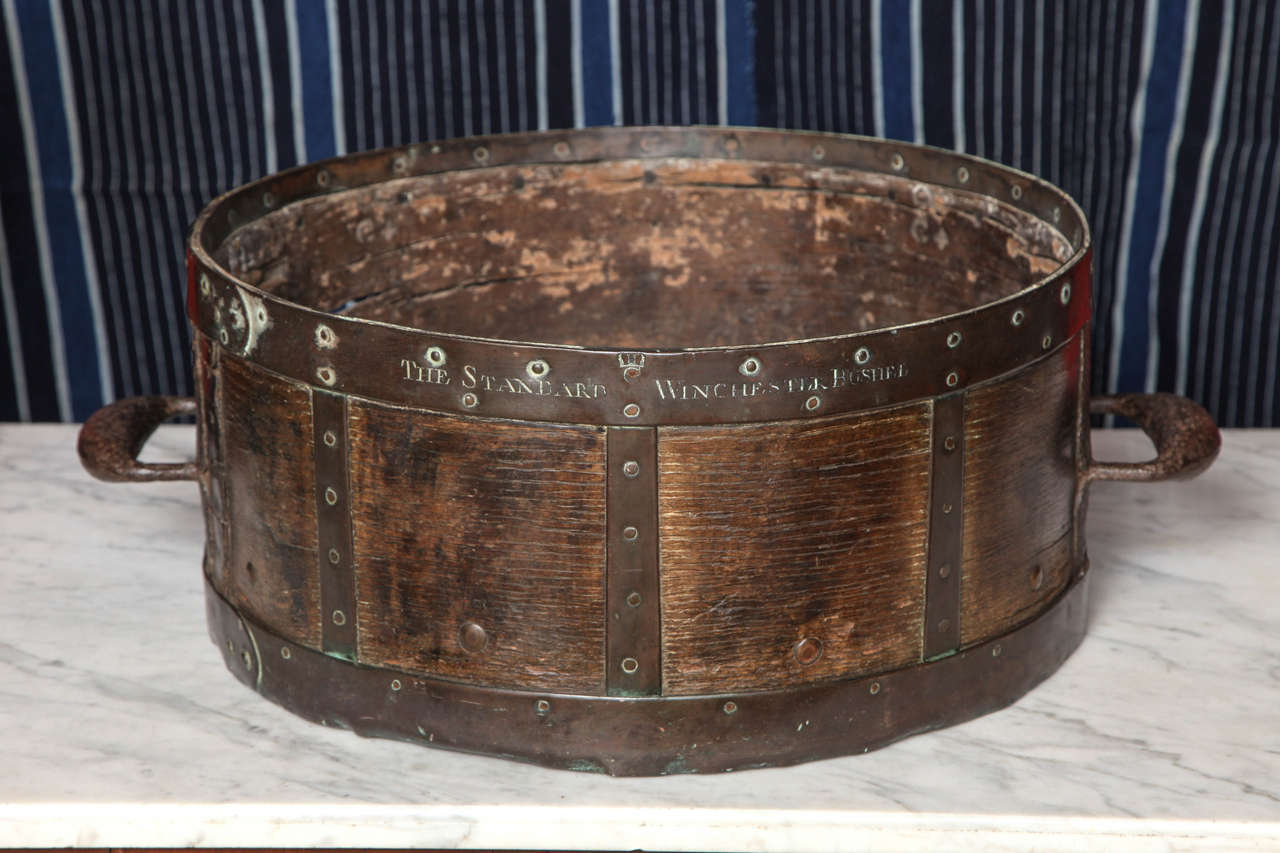 Rare 18th century (1770) English oak, bronze and iron bushel measure, the banding impressed 