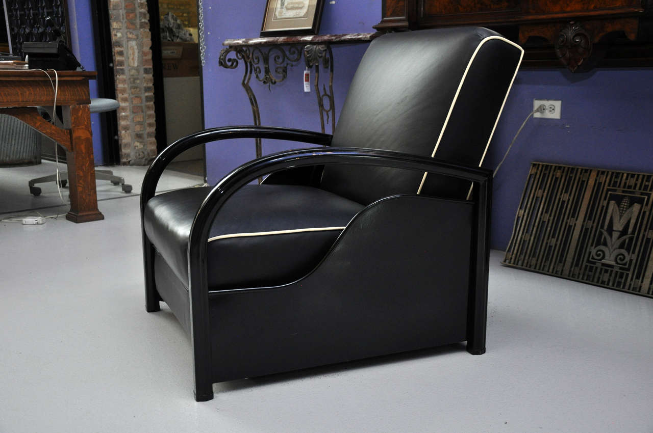 Art Deco lounge chair that converts into a bed. Upholstered in black leather with white leather trim.