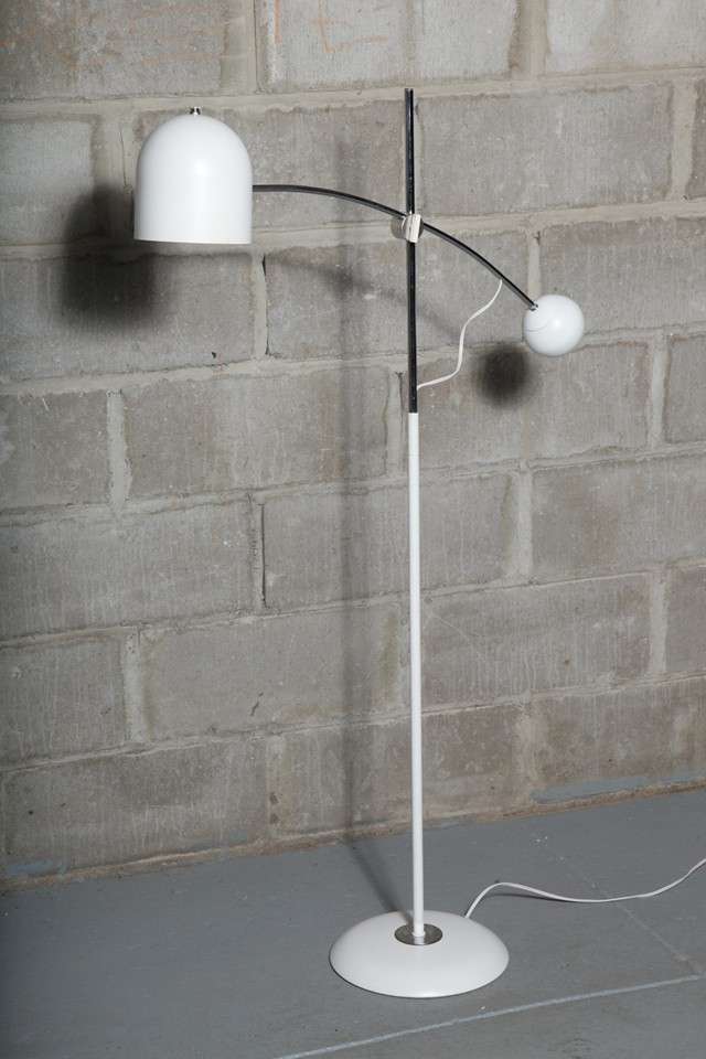 The beauty of this lamp is in its minimal lines and the curve of the pivoting arm.  The helmet shade is 6