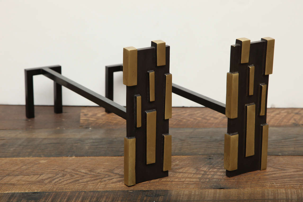 A pair of black patinated and polished gilt bronze andirons by Herve Van Der Straeten.

 