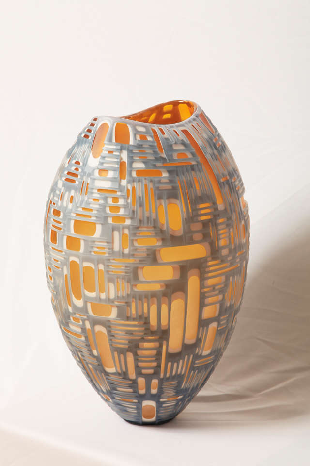 Remarkable glass vase designed and executed by the glass artists Philip Baldwin (1947) and Monica Guggisberg (1955) for their own studio located in Paris (France). Unique piece, 2012.

Multi-layers glass in amber, white and silver grey with a