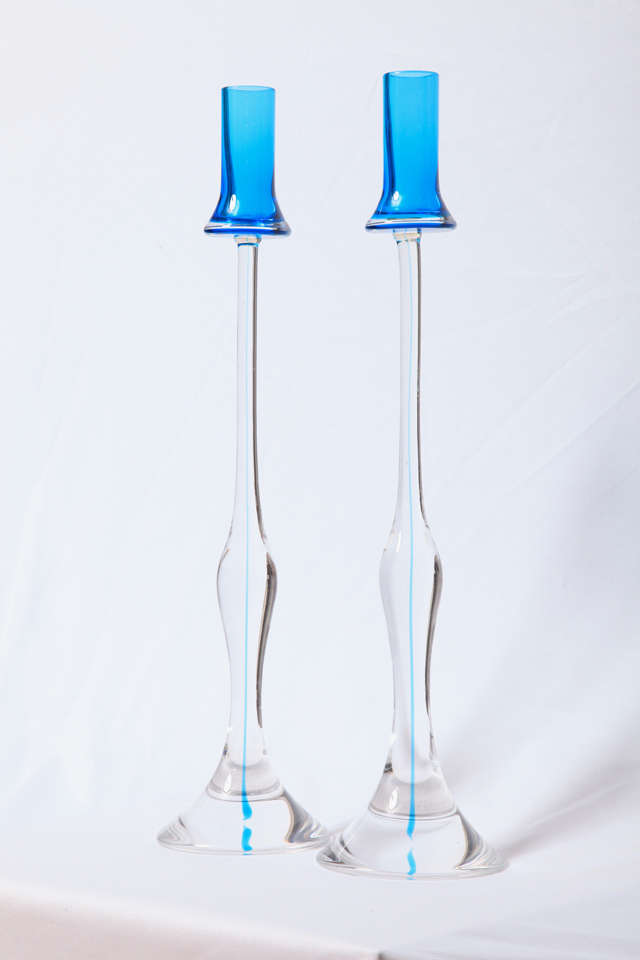 Two tall glass candlesticks  executed by Vetreria Artistica Gino Cenedese, glassworks in Murano, Italy.
Clear glass with a royal blue applied 'head' with a blue inner line.