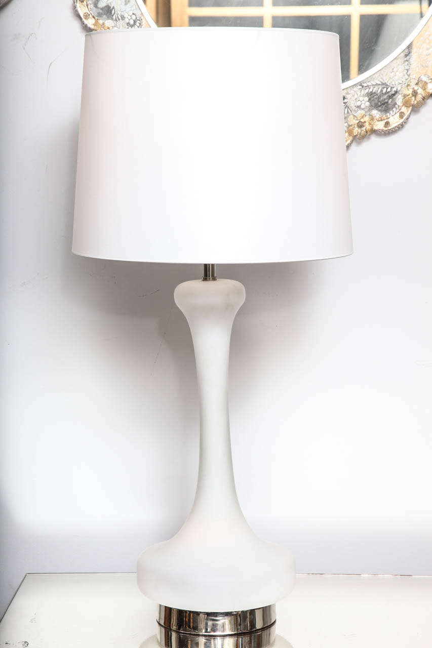 A pair of fabulous white frosted glass Mid-Century lamps designed by Laurel with interior illuminated bases on chrome.