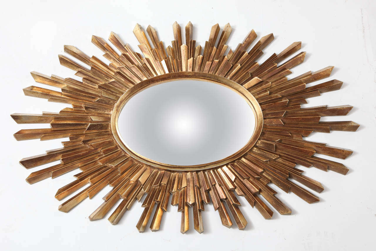 A wonderful oval sunburst mirror with convex glass and giltwood finish.