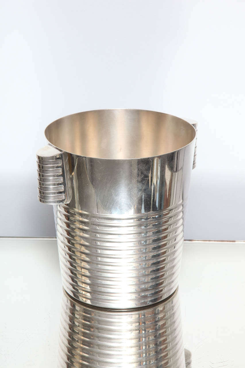 An iconic Art Deco champagne bucket designed by Luc Lanel and manufactured by Christofle. Signature & Marks:  Christofle mark.  France.  OC mark.