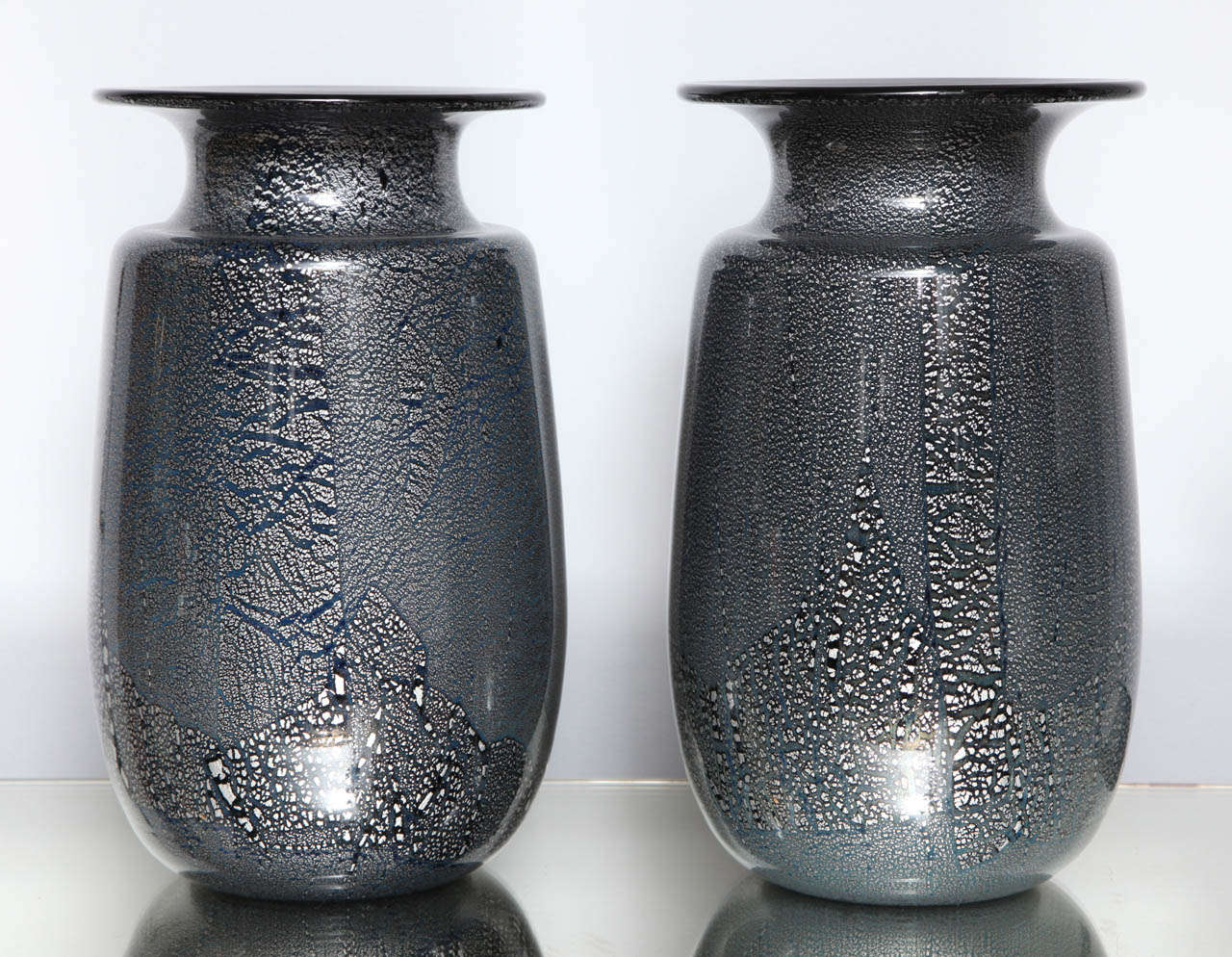 A beautiful pair of Murano glass vases attributed to Seguso Vetri d'Arte with cased silver leaf in clear glass over 'black' glass.