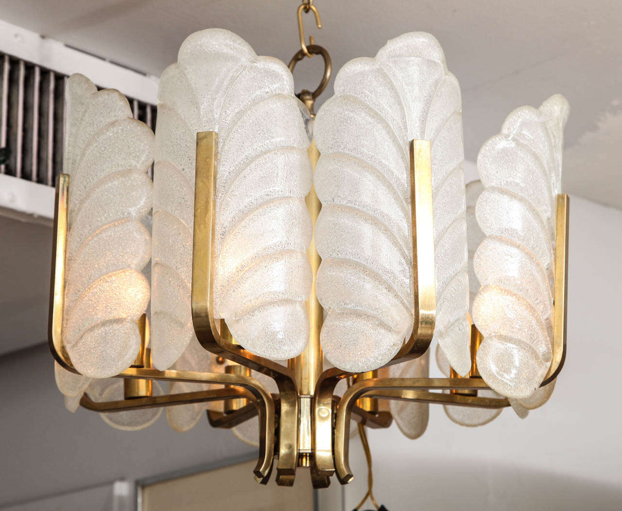 An eight-arm leaf formed frosted Murano glass chandelier on a brass spine and accents. By Carl Fagerlund for Orrefors,