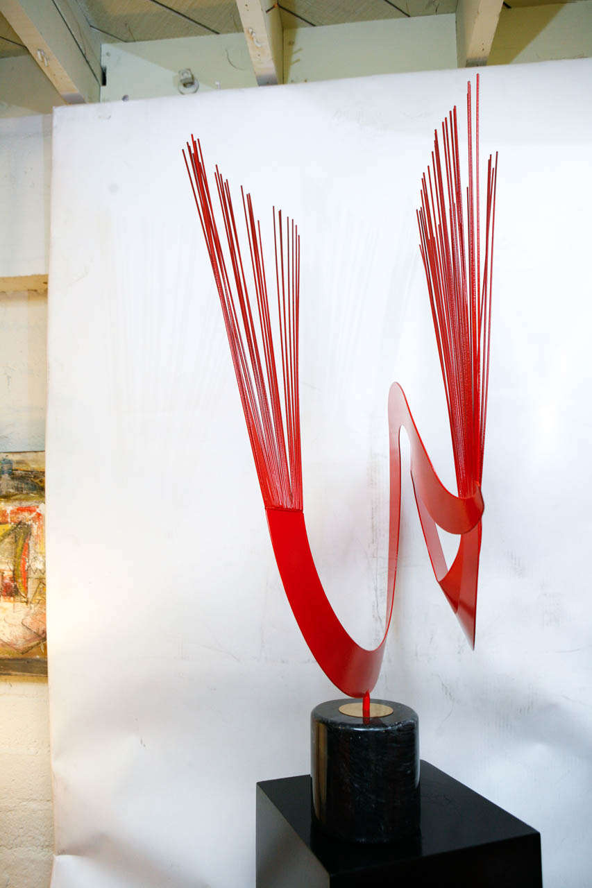 A fabulous Curtis Jere red metal sculpture mounted on a cylindrical marble base.