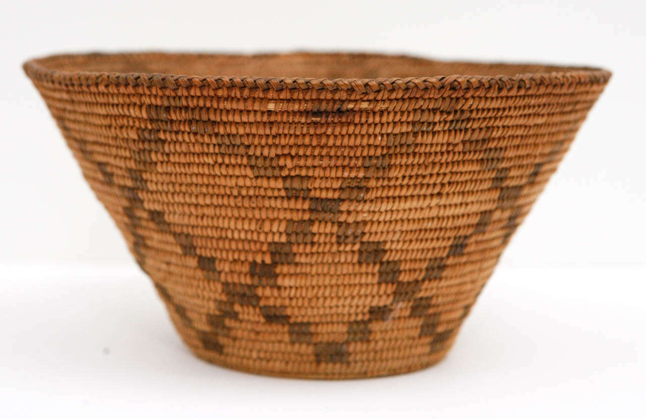 A fine Apache or Pima Native American basket in good condition with attractive dark golden patina. With minor losses. Likely made in late 1890s-early 1900s. Handmade of willow and devil's claw.
 