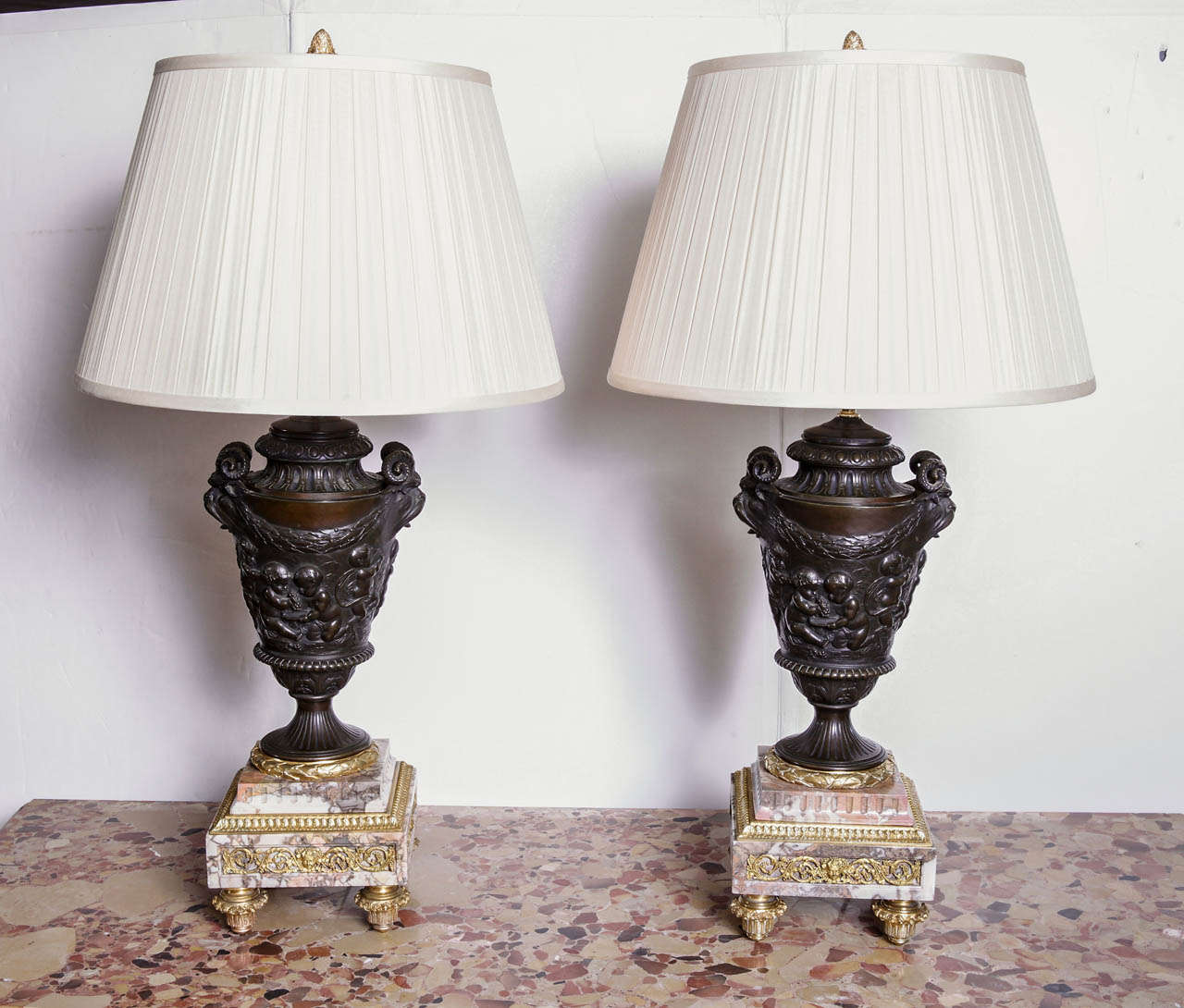19th c pair of Clodion patinated bronze and marble based gilt bronze urn lamps