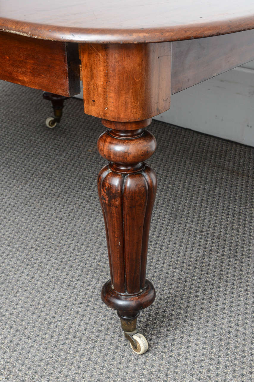 Superb quality antique mahogany dining table made in England.
The table was made circa 1860 , there are two original extra leafs that go into the center.
It sits on the original brass castors and has turned fluted legs.
With the two leafs into