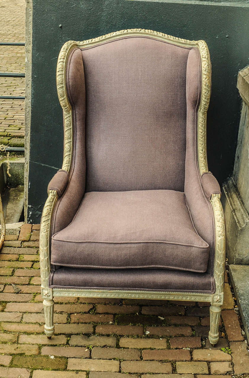 A pair of grey/green patinated fauteuils, with a lavender coloured fabrique.