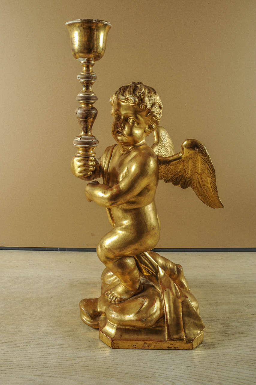 A carved golden angel with a torch.
