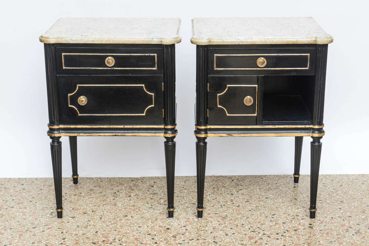 A great pair of commodes with gold details and shaped marble tops. As pictured, one has a single drawer over a single door and the other has a single drawer over a half door. Original restored finish.

Originally $ 2,990.00