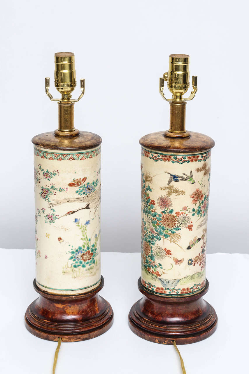 A pair of Chinese porcelain stands that have been made into lamps with wooden caps & bases.  The have been rewired with a single, 3 way socket & a switch in the line.   A great pair at a GREAT price!  The porcelain section is 9.5