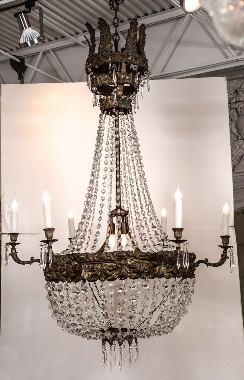 Large Early 19th century large tôle repoussée and crystal chandelier, newly wired with 6 gilded iron arms, three additional center lights, chain and a canopy.