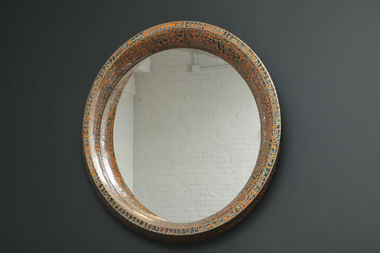Unique mirror by Roland Mellan.  Made of sculpted wood which has been overlaid with copper to follow the sculpture, and layered with different colors of lacquer which are then polished away to create the 