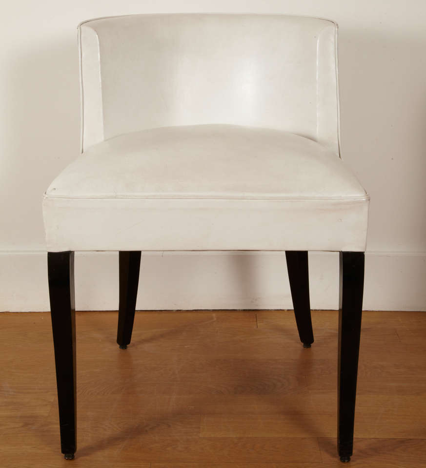 Pair of black varnished and white leather covered chairs. 
Square curved feet.  Curved back.

