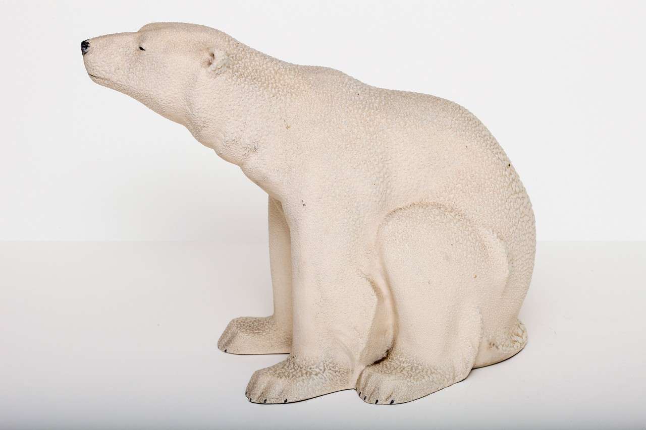A beautifully sculpted polar bear in a seated position by Sevres earthenware. The design is attributed to Francois Pompon, one of the most famous French sculptors of his time (1855-1933).  
The bear is covered in a glacielle glaze which gives this